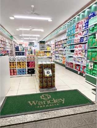Interior da Drogaria do Wancley com corredores e produtos organizados